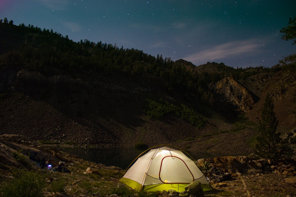 white camping tent near the hill