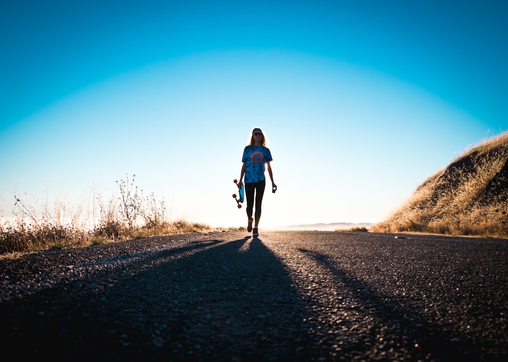 person standing holding skateboard