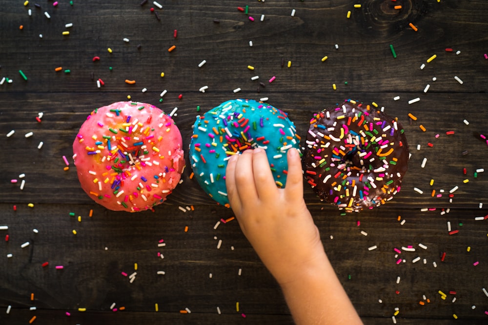 three sprinkled doughnuts