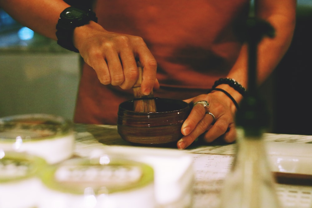 person holding mortar and pestle on table