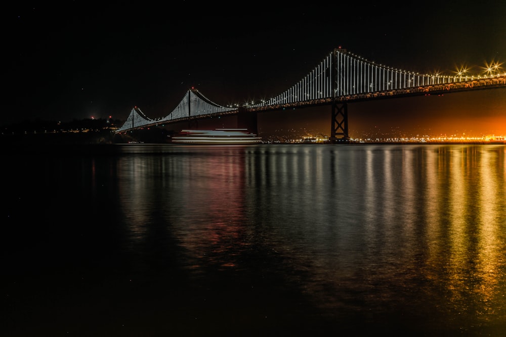 black bridge over body of water during daytime