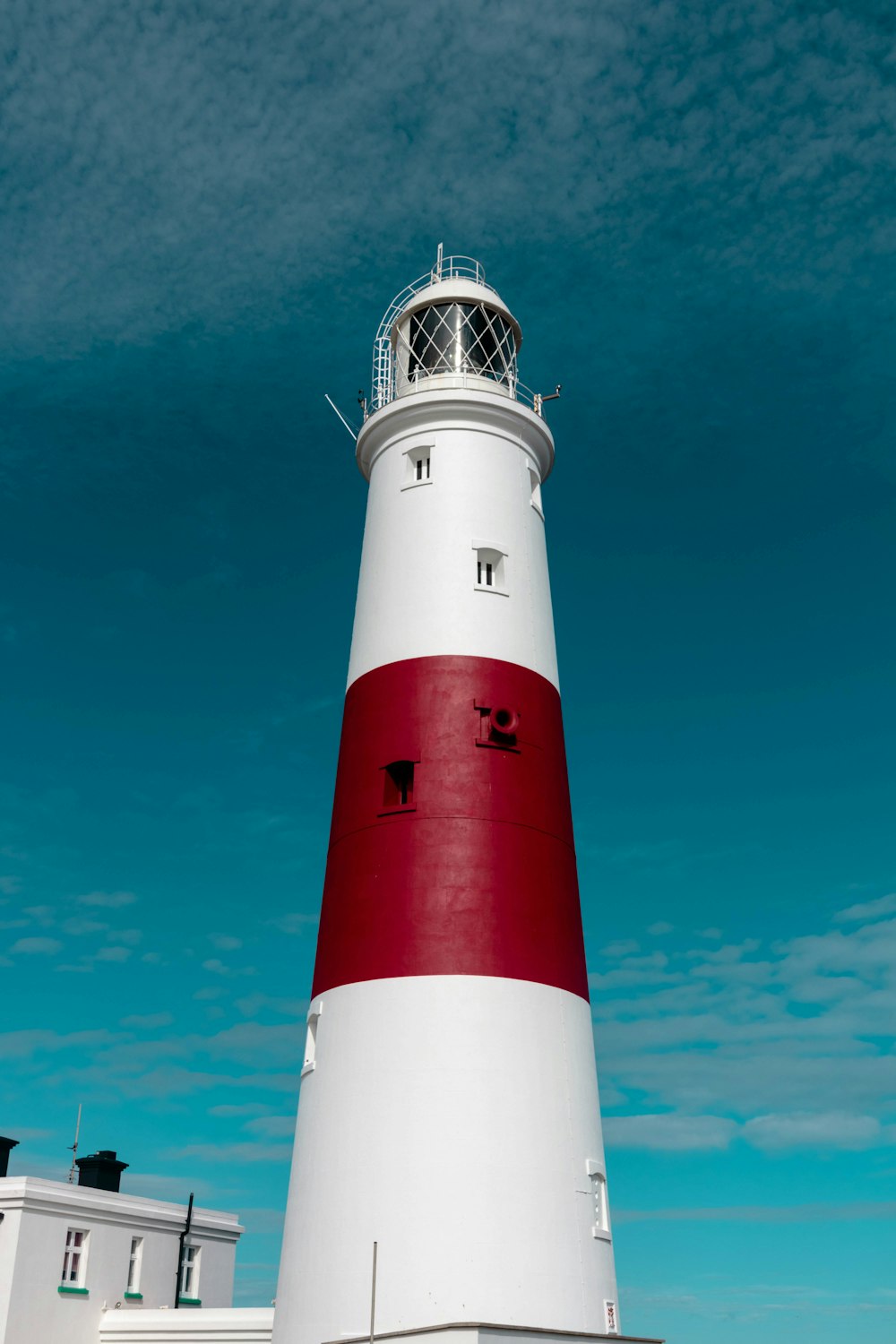 architectural photography of white and red lighthouse