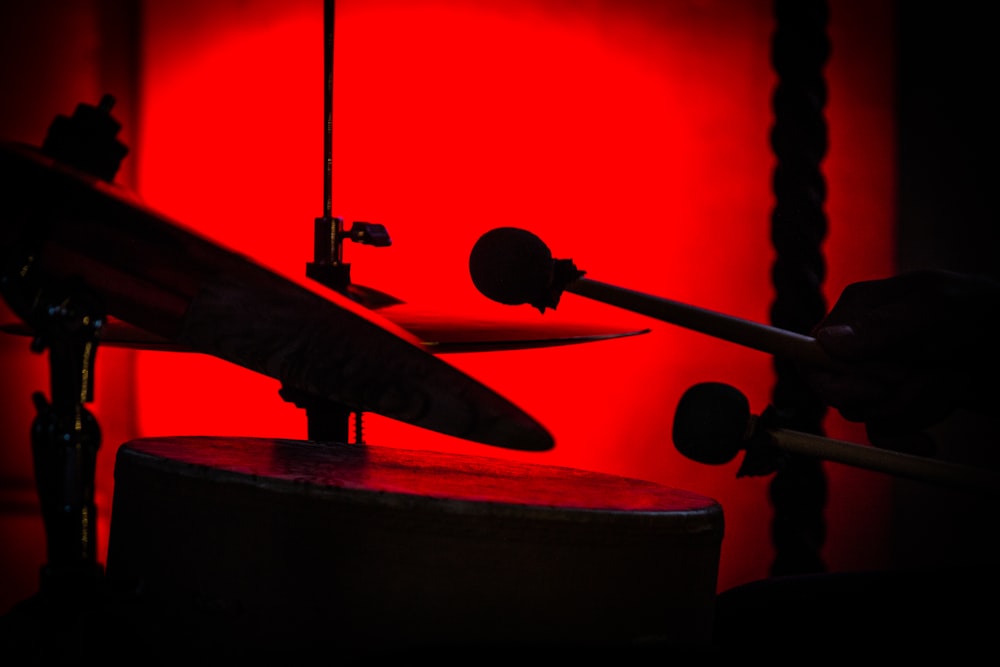 a musical instrument with a red light in the background
