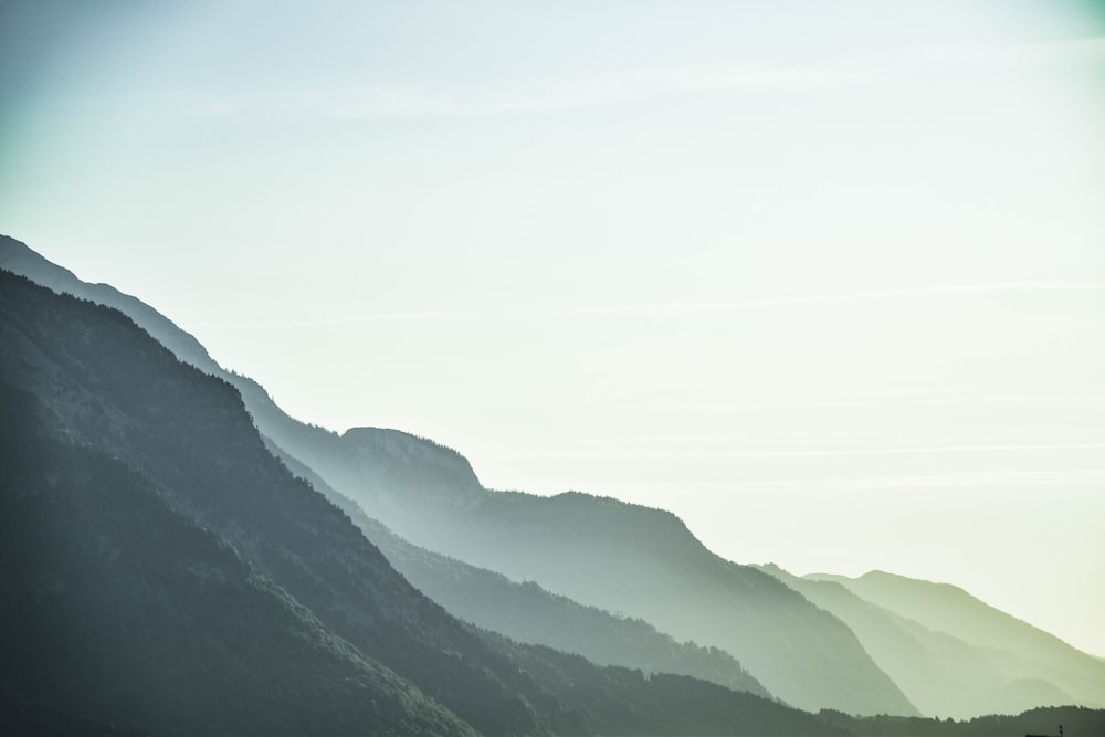 mountains with mist under clear sky