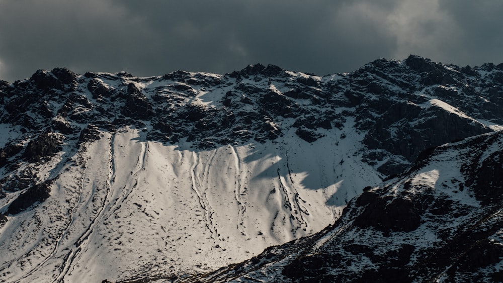 black mountain filled with snow during daytime