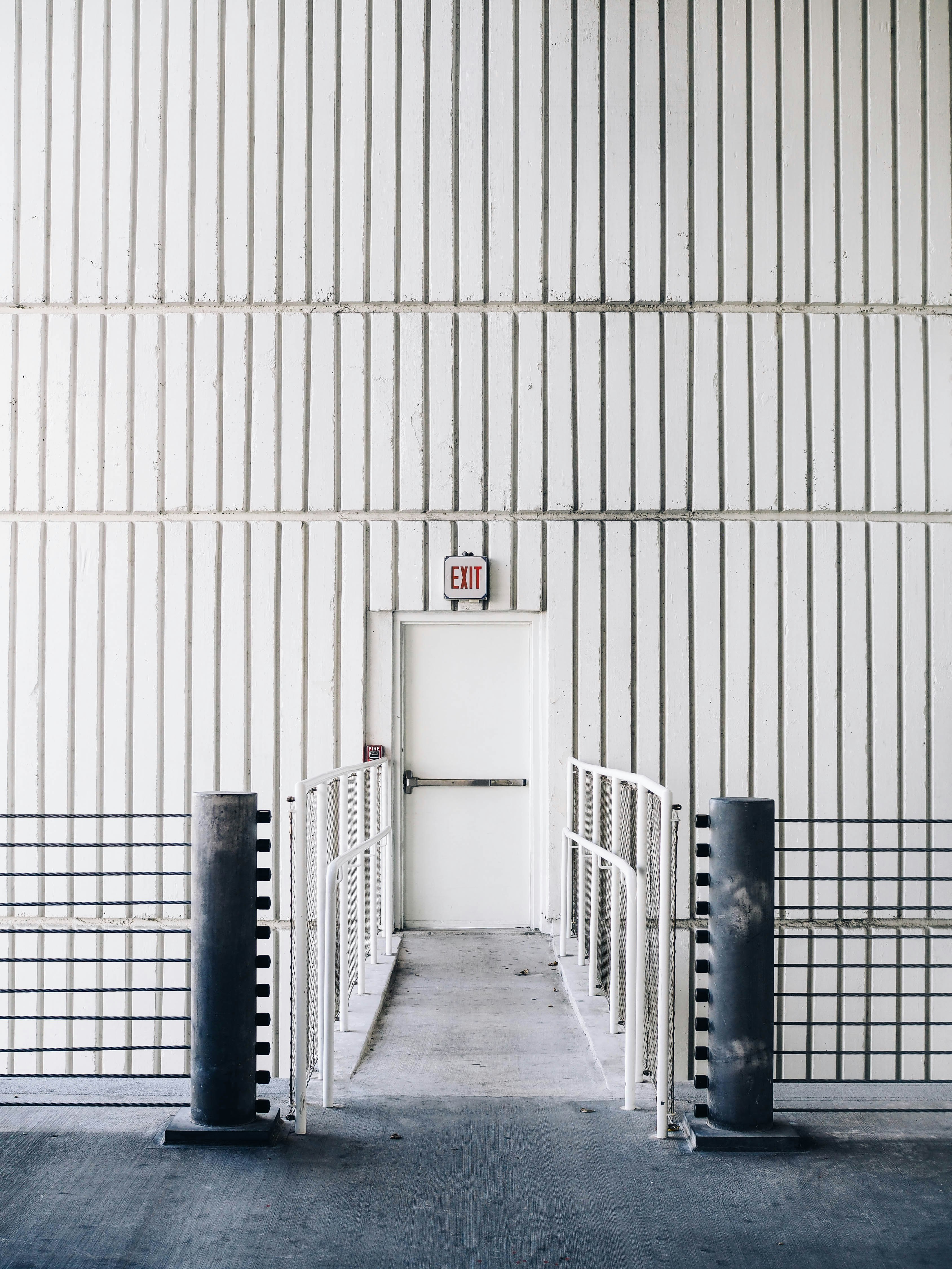 architectural photography of exit door with bridge