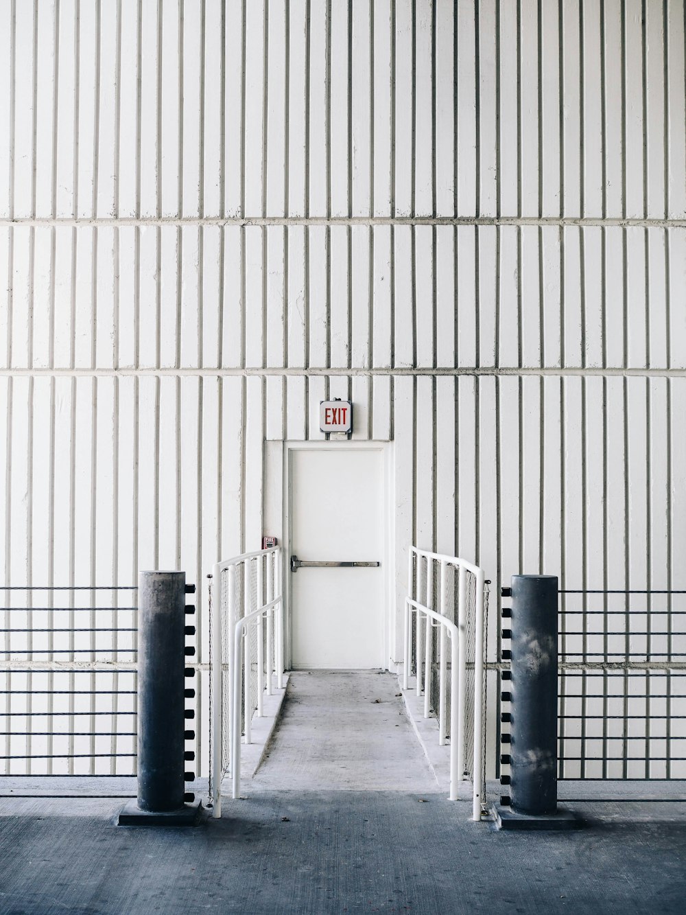 architectural photography of exit door with bridge