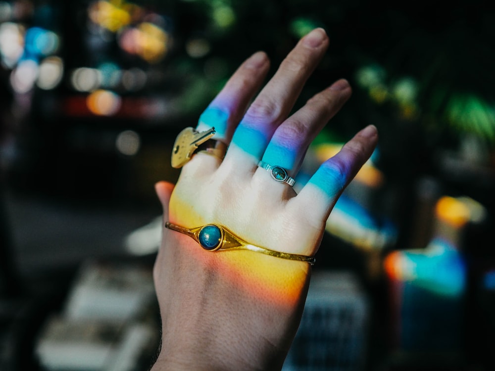 person wearing gold-colored bracelet