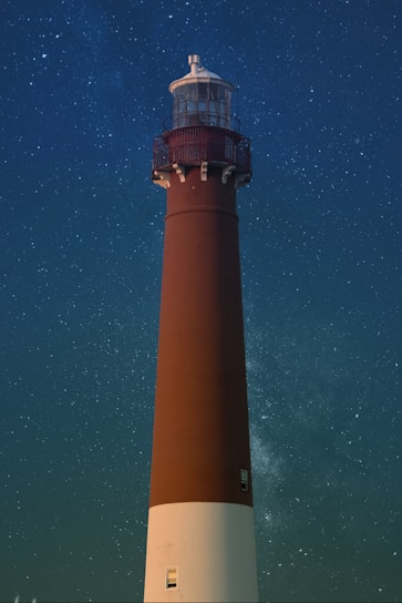 brown and white lighthouse during nighttime