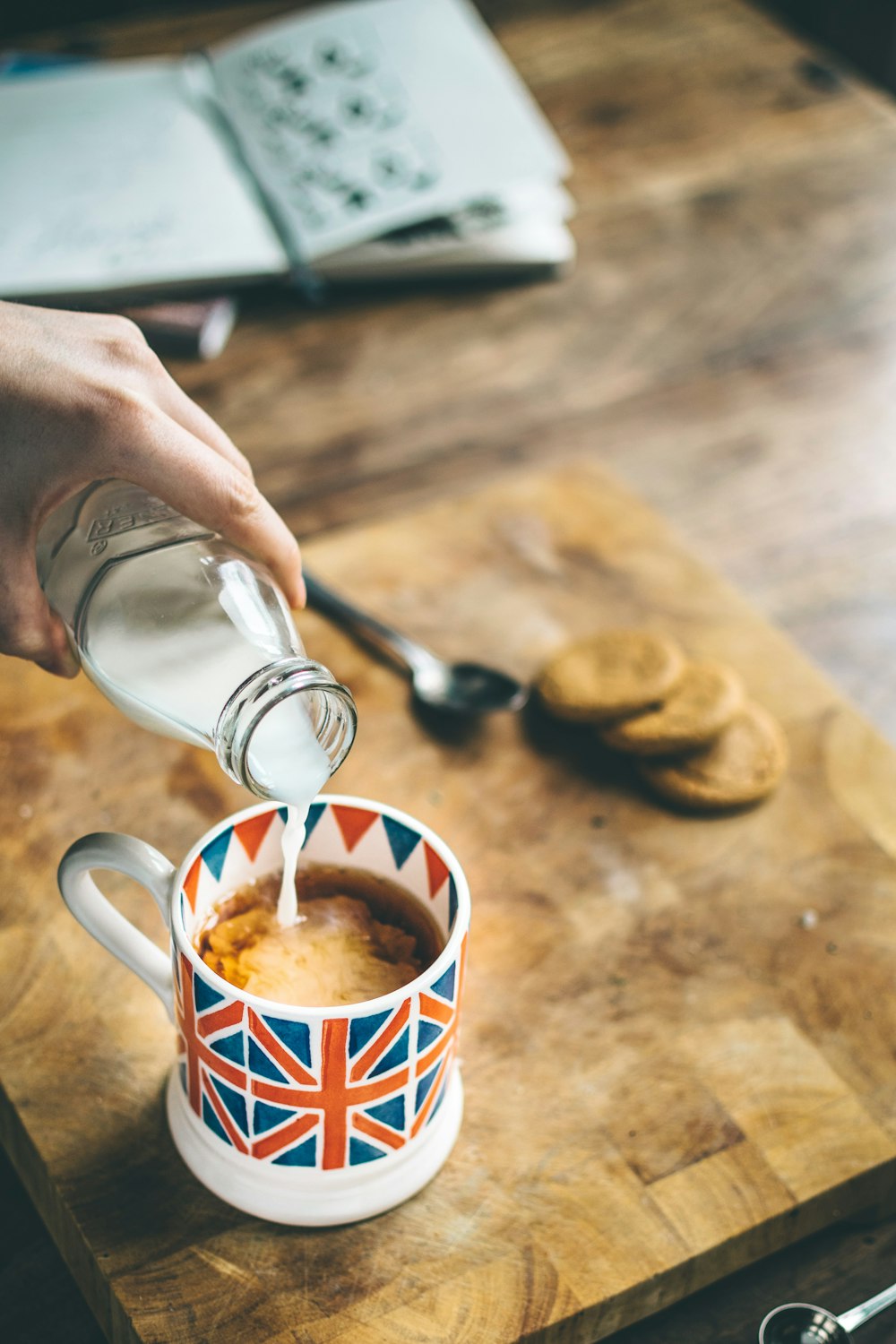 blue, red, and white mug filled with coffee