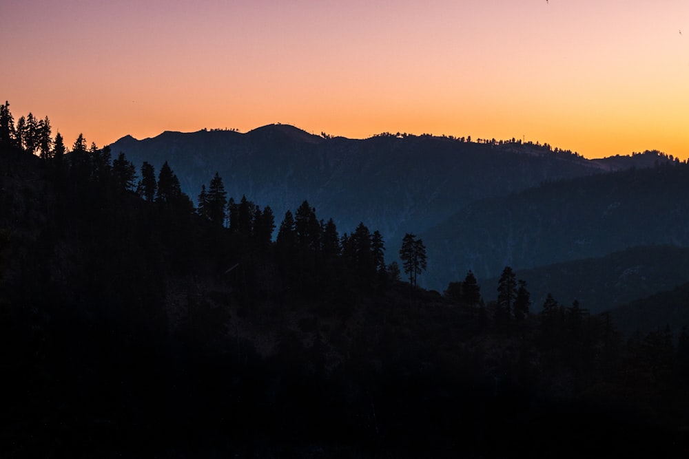 silhouette of mountains under clear sky