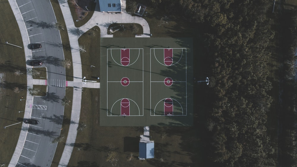 aerial view of 2 basketball courts near road