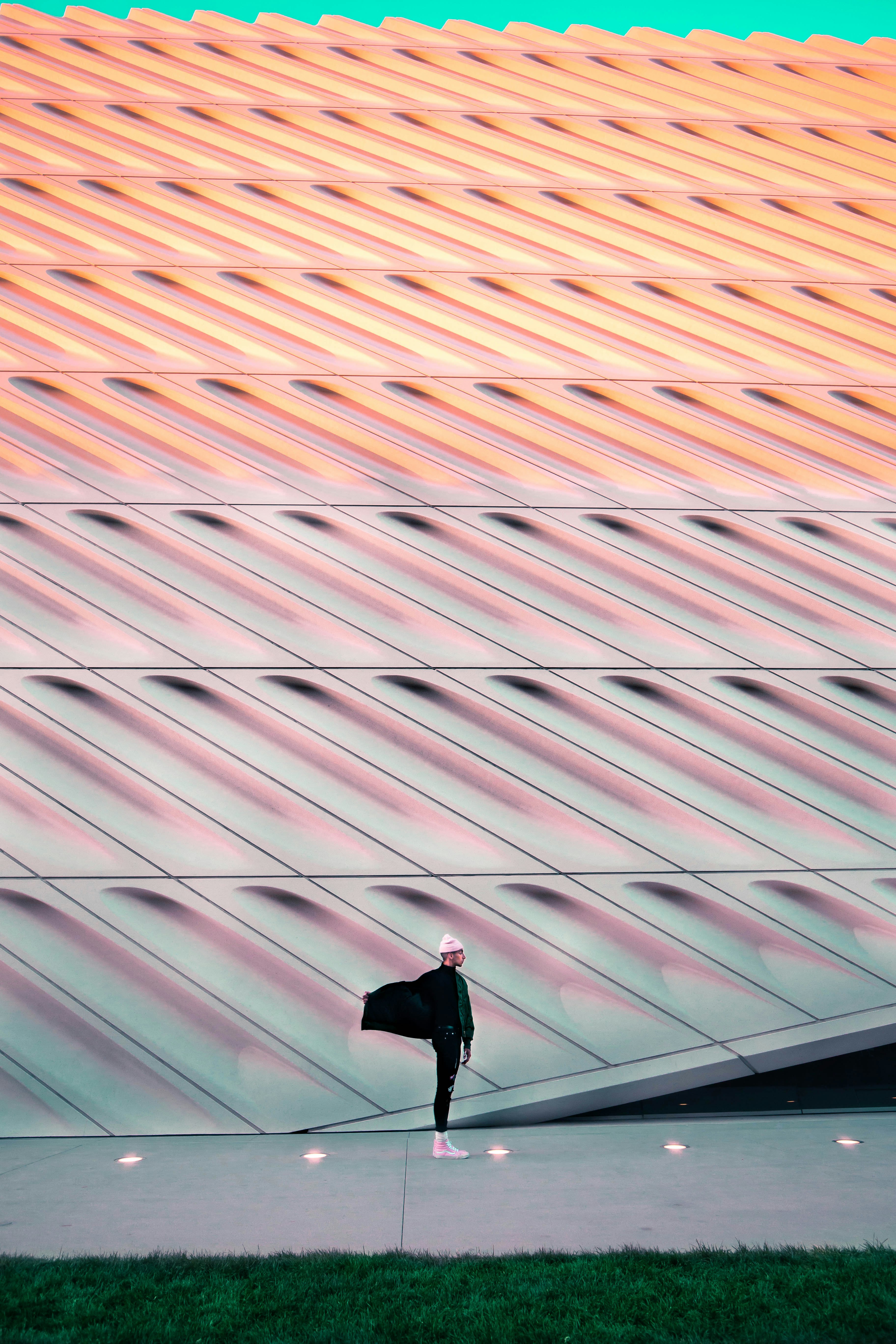 man in black jacket standing on brown and white roof