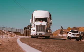 white freight truck on grey concrete road