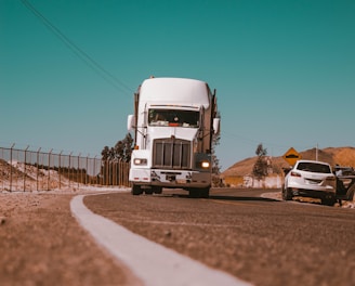 white freight truck on grey concrete road