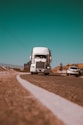 white freight truck on grey concrete road