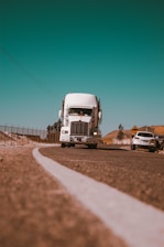 white freight truck on grey concrete road