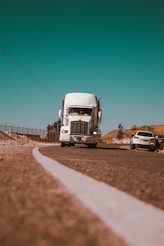 white freight truck on grey concrete road