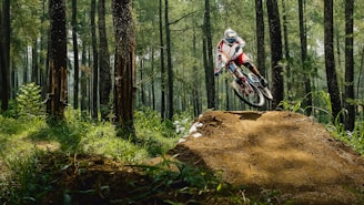 man riding bike doing stunt near green trees during daytime