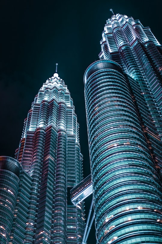 low-angle photography of Petronas twin tower in Perdana Botanical Garden Malaysia
