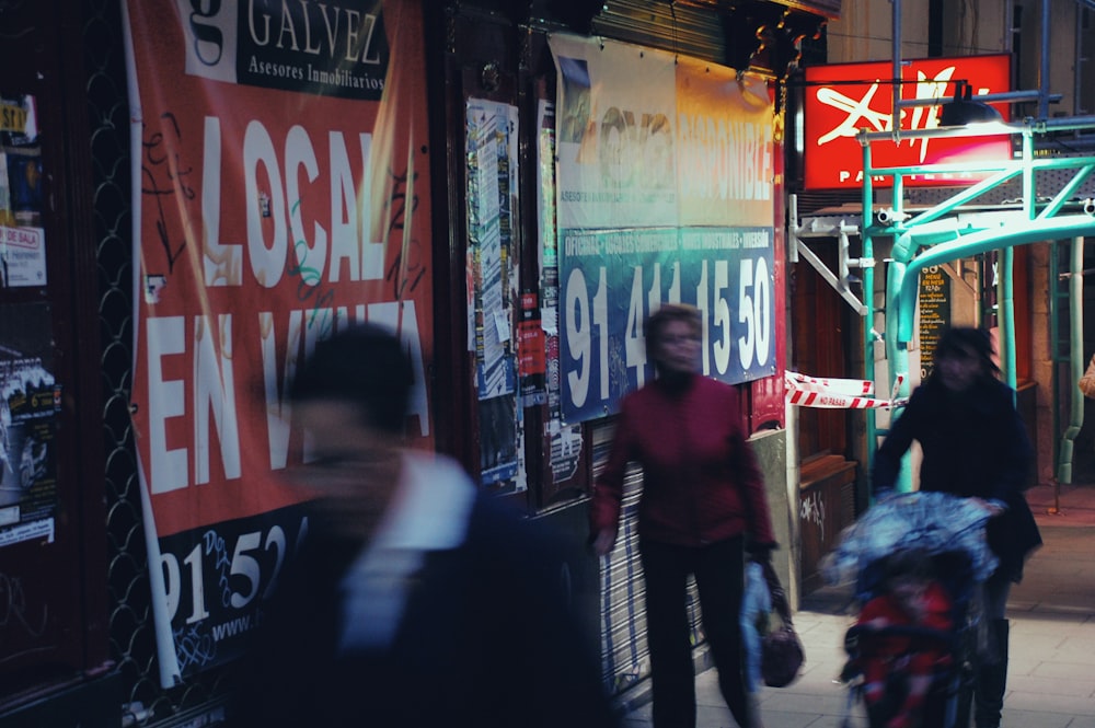 people walking on street during nighttime