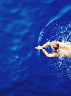 close-up photography of woman swimming on calm water