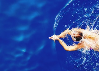 close-up photography of woman swimming on calm water