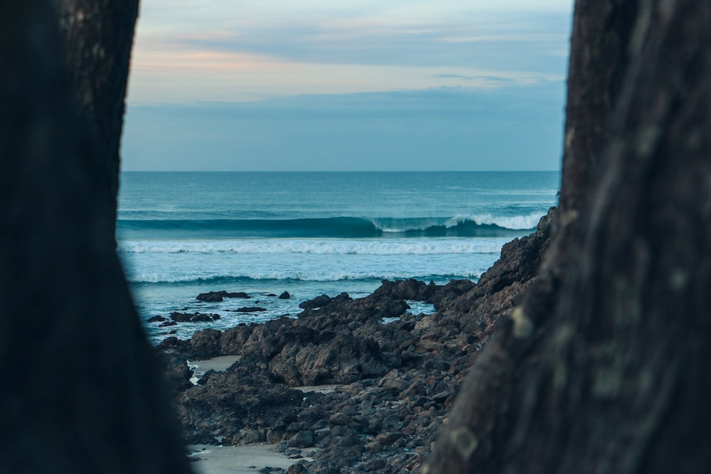 sea with waves near shore under gray sky