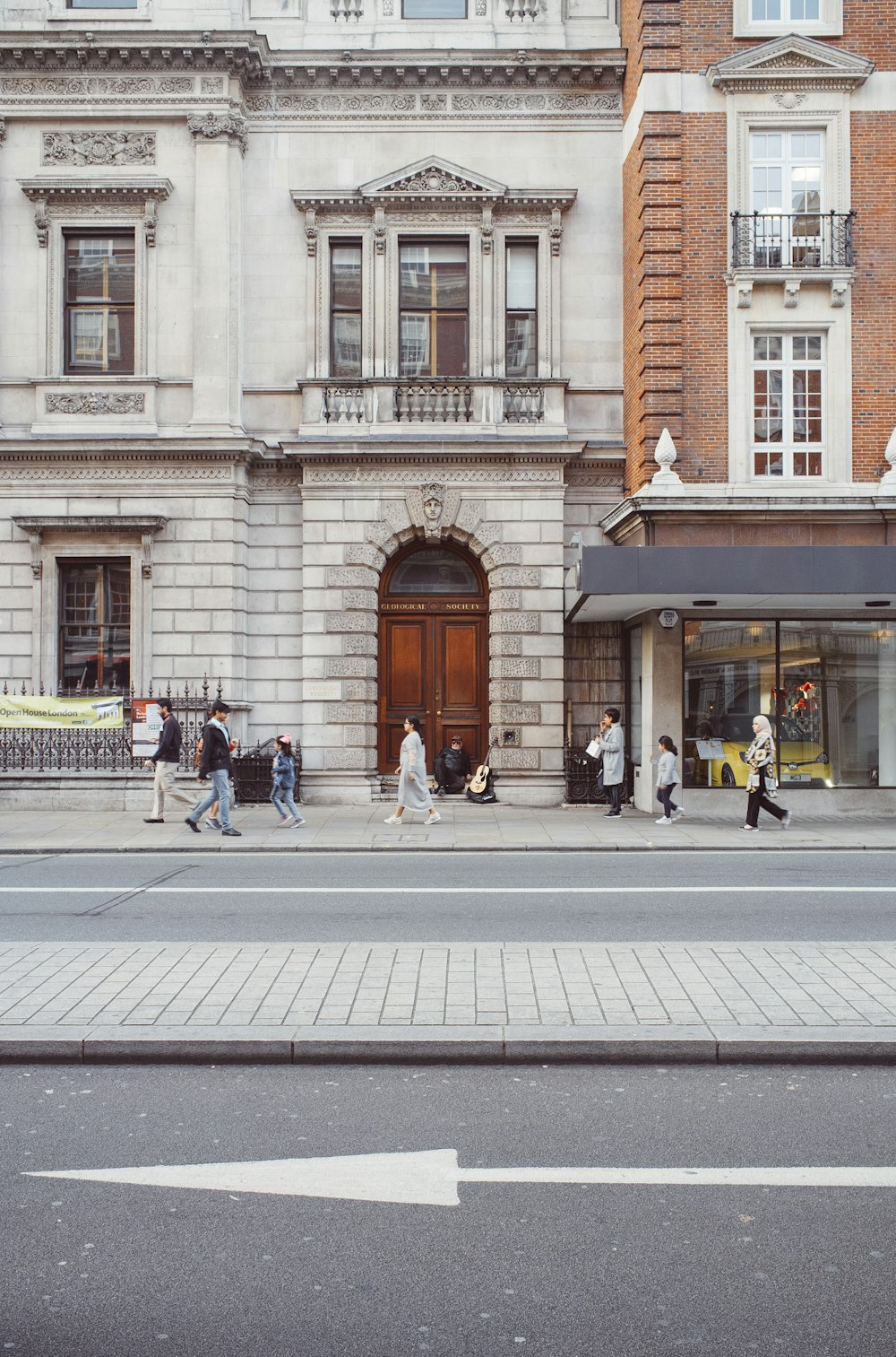 people sitting on bench near building during daytime