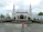 A smiling middle-aged man standing in front of a newly renovated mosque