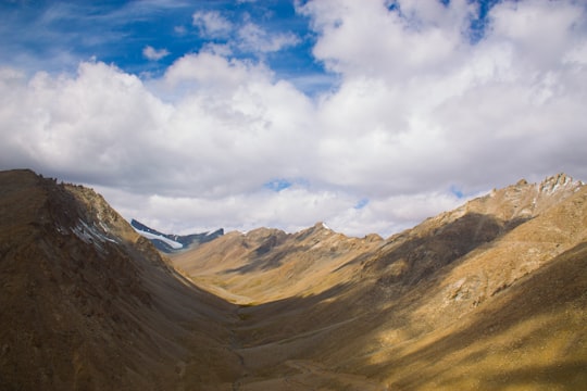 mountain range under cloudy sky during daytime in Leh India