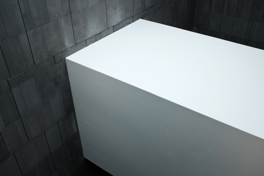 white wooden table on white ceramic floor tiles