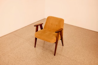 brown wooden framed beige padded chair