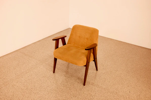 brown wooden framed beige padded chair
