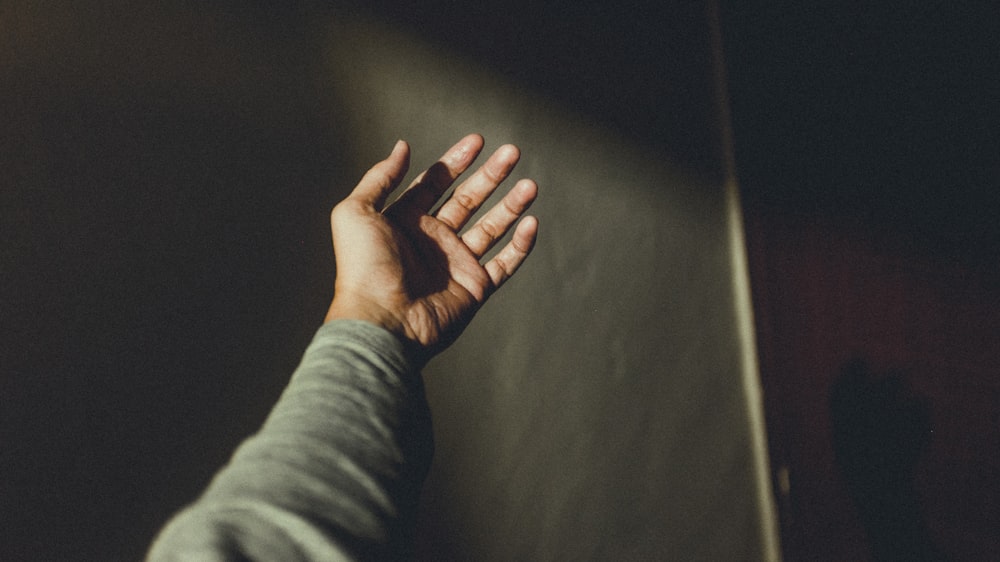 person taking photo of his left hand