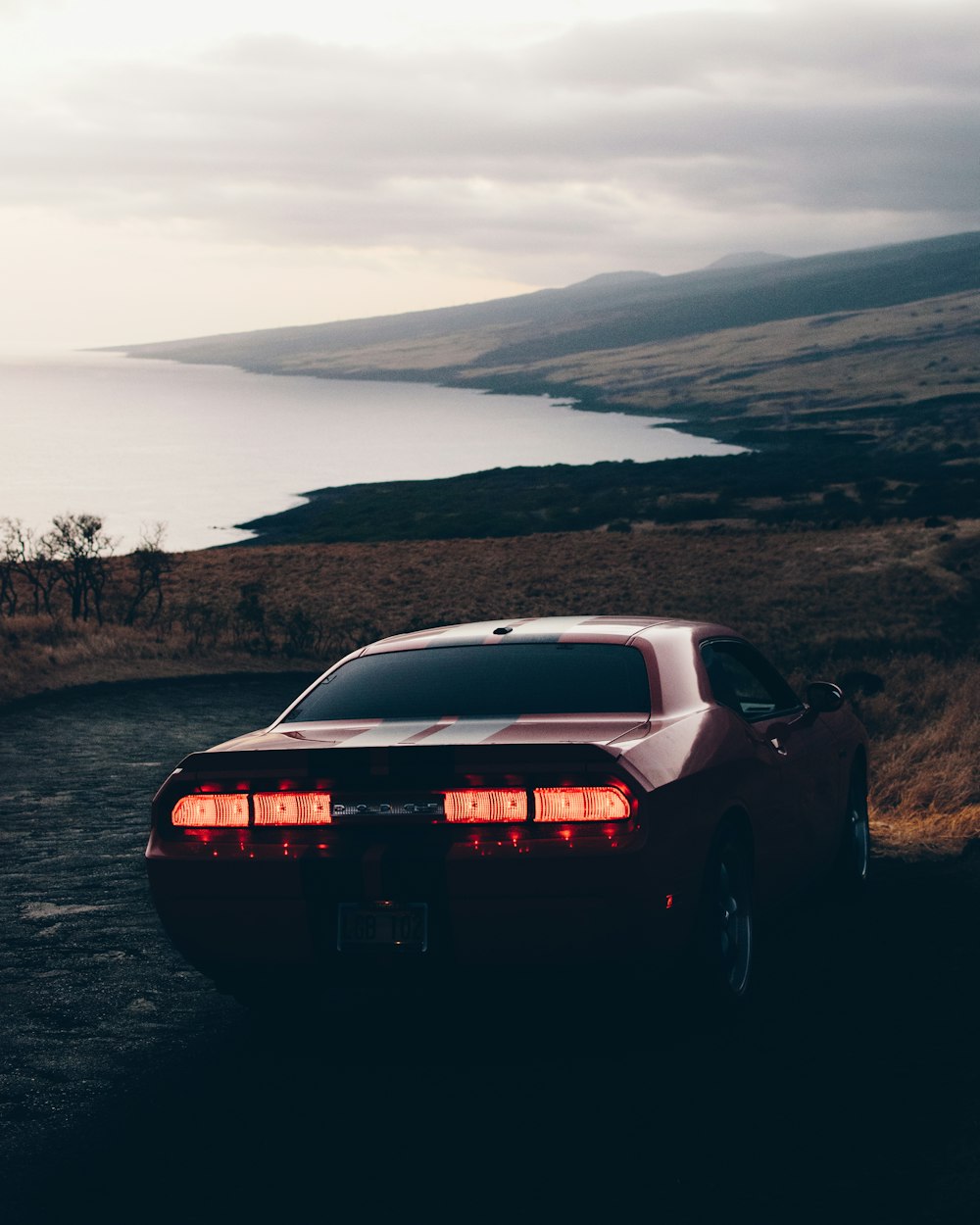 red Dodge Challenger coupe on cliff