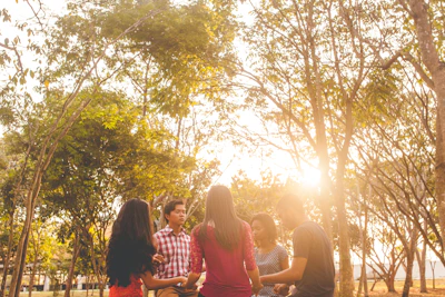 A peaceful outdoor scene where a small group gathers in a circle for a support meeting.