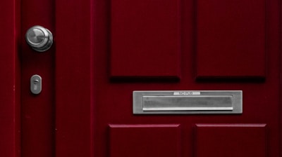 red wooden door with mail box