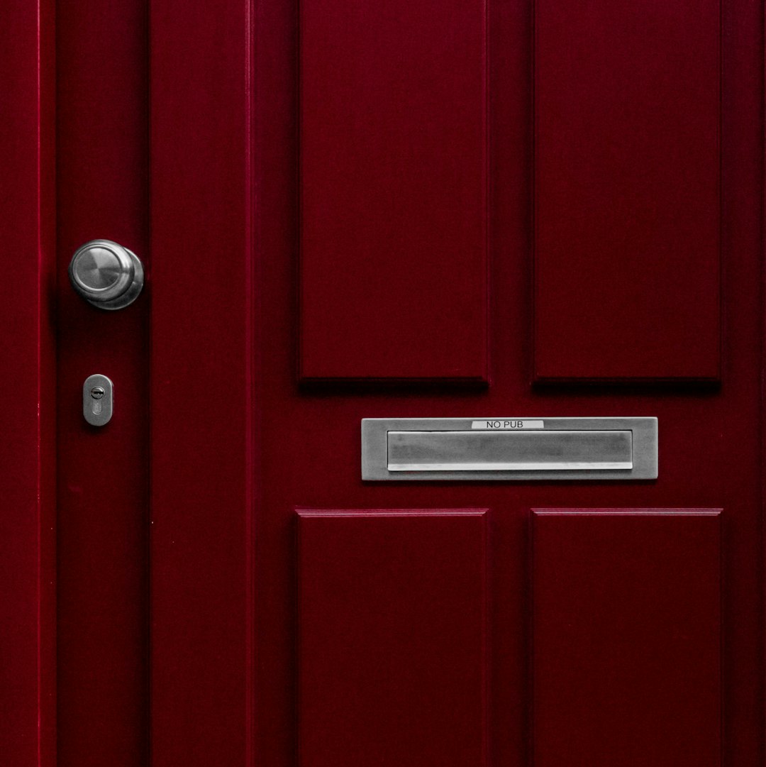 red wooden door with mail box