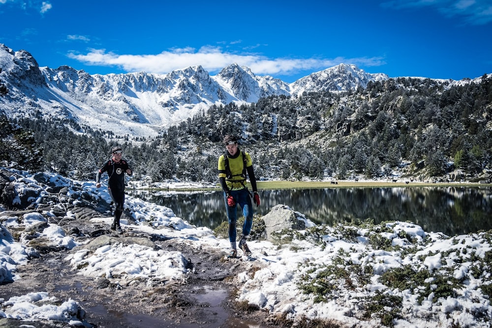 two man on snow covered mountain