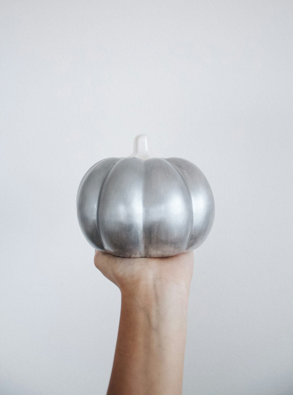 person holding silver round ornament