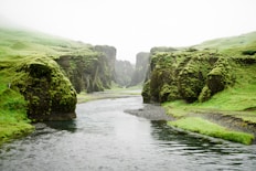 landscape photography of river between green mountains