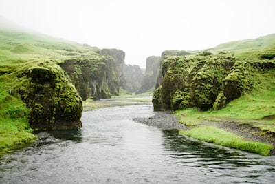 landscape photography of river between green mountains river zoom background