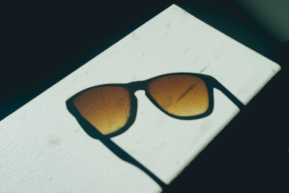 sunglasses on white surface