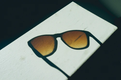 Sunglasses with brown lenses on white surface