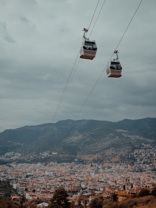 low angle photography of two white cable carts in Alanya Turkey