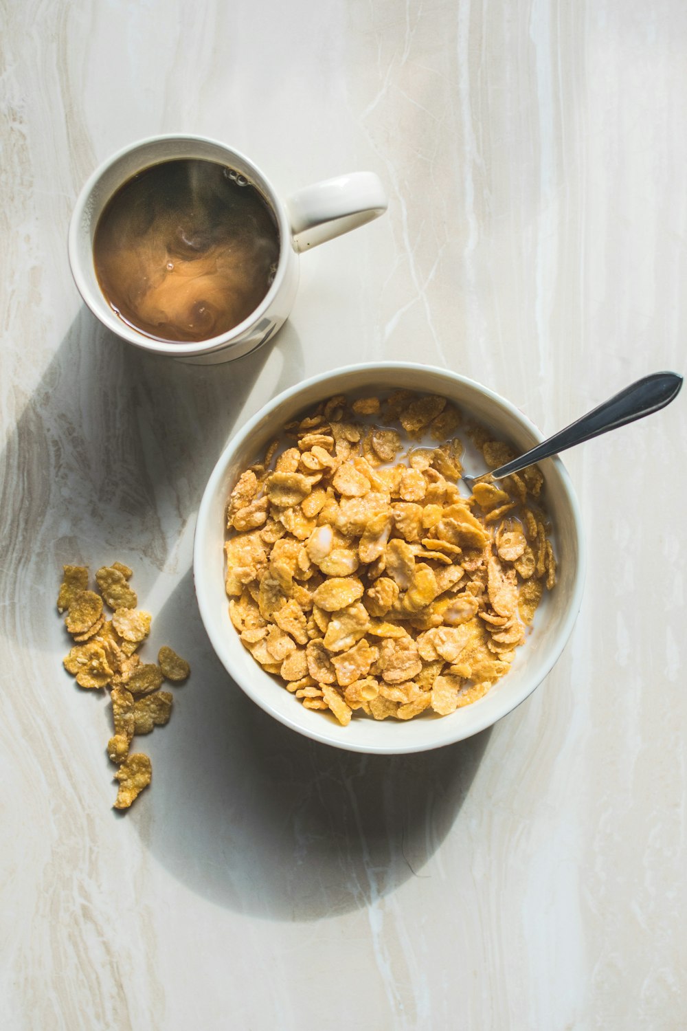ceramic bowl filled with cereals and spoon