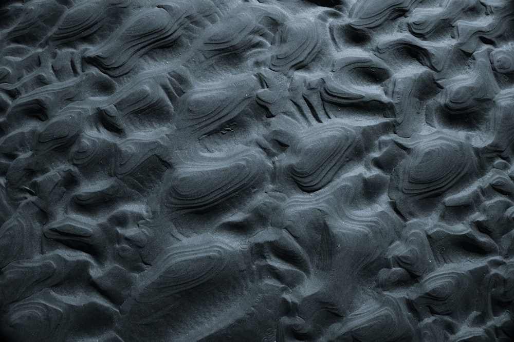 a black and white photo of rocks and sand