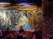 Artistic wall mural inside the club featuring vibrant colors and cultural motifs.