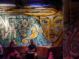 Artistic wall mural inside the club featuring vibrant colors and cultural motifs.